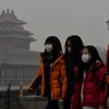 Khách du lịch đeo khẩu trang tránh bụi tại Bắc Kinh. (Nguồn: THX/TTXVN)