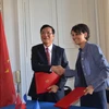 Bộ trưởng Phạm Vũ Luận và bà Najat Vallaud Belkacem trao đổi thỏa thuận hợp tác. (Ảnh: Tiến Nhất-Việt Sơn/Vietnam+)