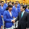Chủ tịch nước Trương Tấn Sang với các huấn luyện viên và vận động viên đạt thành tích cao tại SEAgames 28. (Ảnh: Nguyễn Khang/TTXVN)