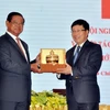 Phó Thủ tướng Phạm Bình Minh và Phó Thủ tướng Campuchia Samdech Krolahom Sar Kheng trao tặng quà lưu niệm. (Ảnh: Thanh Vũ/TTXVN)