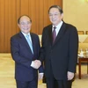 Chủ tịch Quốc hội Nguyễn Sinh Hùng hội kiến ông Du Chính Thanh. (Ảnh: Nhan Sáng/TTXVN)