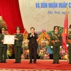 Chủ tịch nước Trương Tấn Sang trao Huân chương Quân công hạng Nhì tặng cho Ngành Quân nhu Quân đội. (Ảnh: Nguyễn Khang/TTXVN)