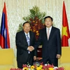 Bí thư Thành ủy Đinh La Thăng tiếp Tổng Bí thư, Chủ tịch nước Lào Bounnhang Volachith tại Dinh Thống Nhất. (Ảnh: Hoàng Hải/TTXVN)
