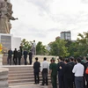 Đoàn Đại sứ quán, các cơ quan xung quanh Sứ quán, đại diện doanh nghiệp Việt Nam đang đầu tư kinh doanh tại Campuchia và cộng đồng người Việt Nam định cư tại Campuchia đặt vòng hoa viếng Đài tưởng niệm quân tình nguyện Việt Nam ở thủ đô Phnom Penh. (Ảnh: 