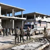 Lực lượng ủng hộ Chính phủ Syria sau khi giành lại quyền kiểm soát quận Myessar, phía Đông Aleppo ngày 4/12. (Nguồn: AFP/TTXVN)