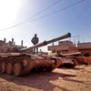 Xe tăng của IS tấn công vào sâu bên trong khu vực hiện do chính phủ kiểm soát ở thành phố Deir Ezzor. (Nguồn: AFP) 