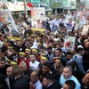 Người Palestine ở Nablus giơ cao những bức ảnh của người thân đang bị giam giữ trong các nhà tù của Israel trong một cuộc míttinh nhân Ngày Tù nhân Palestine. (Nguồn: Xinhua)
