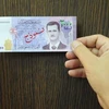 Tờ giấy bạc mới trị giá 2.000 bảng có hình ông al-Assad. (Nguồn: SANA)