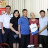 Phó Tổng Giám đốc TTXVN Đinh Đăng Quang tặng quà cho hộ gia đình thương binh, liệt sỹ, người có công trên địa bàn thành phố Hà Giang. (Nguồn: TTXVN)