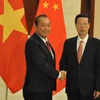 Phó Thủ tướng Trương Hòa Bình (trái) hội kiến Phó Thủ tướng Trung Quốc Trương Cao Lệ. (Ảnh: Lê Trung Kiên/TTXVN)