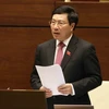 Phó Thủ tướng, Bộ Trưởng Bộ Ngoại giao Phạm Bình Minh giải trình, tiếp thu ý kiến của đại biểu Quốc hội nêu. (Ảnh: Phương Hoa/TTXVN)