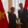 Ông Magyar Levente, Thứ trưởng thường trực Bộ Ngoại giao và Kinh tế Đối ngoại Hungary, trao Huân chương cho Đại sứ Nguyễn Thanh Tuấn. (Nguồn: Vietnam+)