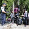 Cảnh sát Hoàng gia Canada kiểm tra một gia đình người tị nạn Haiti vào Canada từ Champlain, New York. (Nguồn: Reuters/TTXVN)