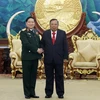 Tổng Bí thư, Chủ tịch nước Lào tiếp Đại tướng Ngô Xuân Lịch. (Ảnh: Phạm Kiên/TTXVN) 