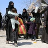 Người dân sơ tán khỏi thị trấn Jisreen, Đông Ghouta. (Nguồn: AFP/TTXVN)