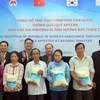 Đại diện lãnh đạo Bộ Nông nghiệp và Phát triển Nông thôn Việt Nam và Bộ Nông nghiệp, lương thực và nông thôn Hàn Quốc trao tặng gạo cho người dân vùng bị thiên tai của huyện Đại Lộc. (Ảnh : Đỗ Văn Trưởng/TTXVN)