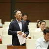 Bộ trưởng Bộ Công Thương Trần Tuấn Anh trả lời chất vấn của đại biểu Quốc hội. (Ảnh: Dương Giang/TTXVN)
