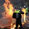 Người biểu tình áo vàng đốt phá trong cuộc biểu tình phản đối việc tăng giá nhiên liệu ở thủ đô Paris. (Nguồn: AFP/TTXVN)