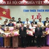 Truy tặng danh hiệu Bà mẹ Việt Nam anh hùng và các gia đình có công với cách mạng tại buổi lễ. (Ảnh: Mai Trang/TTXVN)