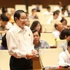 Bộ trưởng Bộ Nội vụ Lê Vĩnh Tân giải trình làm rõ ý kiến của Đại biểu Quốc hội. (Ảnh: Phương Hoa/TTXVN)