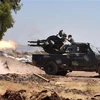 Các lực lượng Syria trong cuộc đụng độ với phiến quân tại khu vực Jabriya, tỉnh Hama. (Nguồn: AFP/TTXVN)