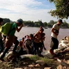Người di cư vượt sông Suchiate từ Tecun Uman (Guatemala) để tới Ciudad Hidalgo, Chiapas (Mexico), trong hành trình tới Mỹ. (Nguồn: AFP/TTXVN)