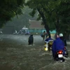 Các phương tiện di chuyển khó khăn trên đường Mai Xuân Thưởng sau cơn mưa lớn tại Hà Nội. (Ảnh: Thống Nhất/TTXVN)