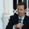 Tổng thống Syria Bashar al-Assad trả lời phỏng vấn báo giới tại Damascus. (Ảnh: AFP/TTXVN)