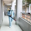 Nhân viên y tế phun thuốc tiêu độc khử trùng tại trường THPT Chuyên Hưng Yên, thành phố Hưng Yên. (Ảnh: Phạm Kiên/TTXVN)
