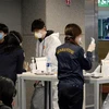 Du khách Hàn Quốc được kiểm tra thân nhiệt nhằm ngăn dịch COVID-19 tại khu vực kiểm dịch ở sân bay quốc tế Incheon, phía tây Seoul. (Ảnh: YONHAP/TTXVN)