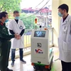 Đại diện Học viện kỹ thuật quân sự giới thiệu robot với các bác sỹ bệnh viện Bắc Thăng Long. (Ảnh: TTXVN phát)
