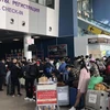Công dân Việt Nam tập trung tại sân bay Vladivostok, Nga, chuẩn bị lên đường về nước. (Ảnh: TTXVN phát)