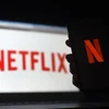 Biểu tượng Netflix trên màn hình máy tính và điện thoại di động. (Ảnh: AFP/TTXVN)