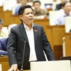Bộ trưởng Bộ Giao thông vận tải Nguyễn Văn Thể trả lời chất vấn của các đại biểu Quốc hội. (Ảnh: Doãn Tấn/TTXVN)