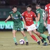 Pha tranh bóng giữa các cầu thủ đội Thành phố Hồ Chí Minh (áo đỏ) và đội Sài Gòn FC. (Ảnh: Thanh Vũ/TTXVN)