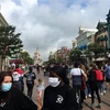 Du khách vẫn phải đeo khẩu trang khi tới thăm công viên Disneyland ở thủ đô Paris. (Ảnh: AFP/TTXVN)