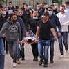 Người biểu tình Palestine bị thương trong cuộc xung đột với cảnh sát Israel tại khu đền thờ Al-Aqsa ở Jerusalem ngày 10/5. (Ảnh: AFP/TTXVN)