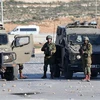 Lực lượng an ninh Israel trong cuộc đụng độ với người biểu tình Palestine tại thành phố Ramallah thuộc khu Bờ Tây hồi tháng 1/2023. (Ảnh: AFP/TTXVN)