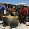 Phân phát thức ăn cứu trợ cho trẻ em tại huyện Howlwadag, Somalia. (Ảnh: AFP/TTXVN)