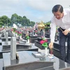 Trưởng Ban Nội chính Trung ương Phan Đình Trạc thắp hương các phần mộ liệt sĩ tại Nghĩa trang Liệt sĩ tỉnh Đắk Lắk. (Ảnh: TTXVN phát)