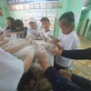 Các tình nguyện viên của Hansae Yes24 Foundation làm mô hình đất sét cùng các em học sinh tại Trường Nuôi dạy Trẻ Khuyết tật huyện Củ Chi. (Nguồn: Hansae cung cấp)