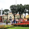 Khách quốc tế vui chơi trong vườn hoa trước Bưu điện Trung tâm và Nhà thờ Đức Bà Thành phố Hồ Chí Minh. (Ảnh: Hồng Đạt/TTXVN)