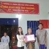 Đoàn thanh niên Thông Tấn Xã Việt Nam tặng quà cho gia đình có nhà mới tại huyện Ba Tri, Bến Tre. (Ảnh: Huỳnh Phúc Hậu/TTXVN)