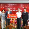 Ông Cao Mạnh Đức, Tổng Giám đốc Công ty Metfone, trao tượng trưng 1.075 suất quà Tết cho Ban lãnh đạo Hội Khmer-Việt Nam tại Campuchia. (Ảnh: Hoàng Minh/TTXVN)