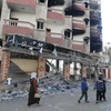 Các tòa nhà bị phá hủy sau cuộc không kích của Israel xuống Dải Gaza ngày 19/1. (Ảnh: THX/TTXVN)