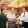 Ông Nguyễn Văn Nên, Ủy viên Bộ Chính trị, Bí thư Thành ủy Thành phố Hồ Chí Minh, thăm hỏi sức khỏe các cựu chiến binh tham dự buổi họp mặt. (Ảnh: Xuân Khu/TTXVN)