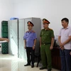 Cơ quan chức năng tống đạt quyết định khởi tố bị can đối với Nguyễn Trường Thi. (Ảnh: TTXVN phát)