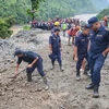 Cảnh sát và lực lượng cứu hộ tìm kiếm người mất tích sau khi 2 xe buýt bị cuốn xuống sông do lở đất tại huyện Chitwan, Nepal. (Ảnh: THX/TTXVN)