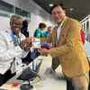 Ông Đặng Hà Việt, Cục trưởng Cục Thể dục Thể thao, Trưởng đoàn thể thao Việt Nam tại Olympic Paris 2024, nhận thẻ tham dự Thế vận hội. (Ảnh: Hoàng Linh/TTXVN)