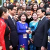 Chủ tịch nước Trương Tấn Sang gặp mặt thân mật các nữ doanh nhân Việt Nam tiêu biểu đạt danh hiệu Cúp Bông Hồng Vàng năm 2013. (Ảnh: Nguyễn Khang/TTXVN)